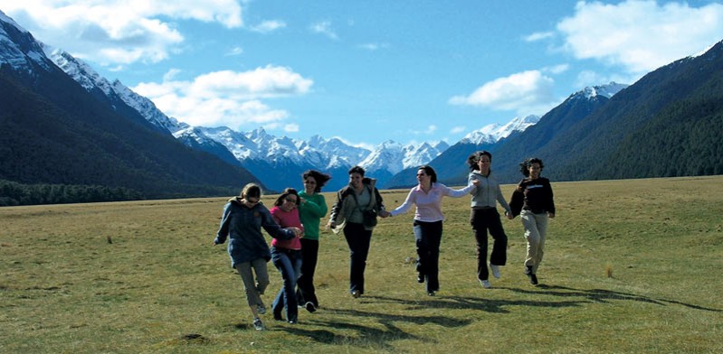 friends jumping in the alps