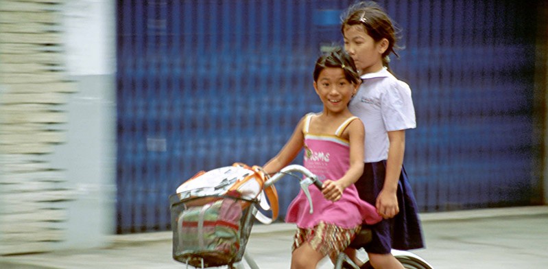 Girls cycling in Vietnam