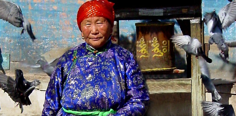mongolia lady in purple dress with red head scarf