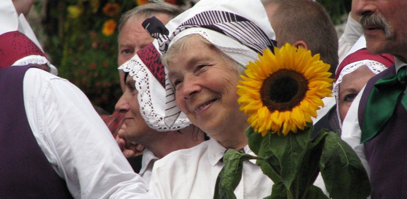 sunflower and local lady in Latvia