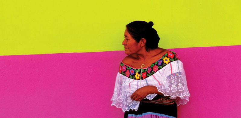 mexican lady standing against a wall