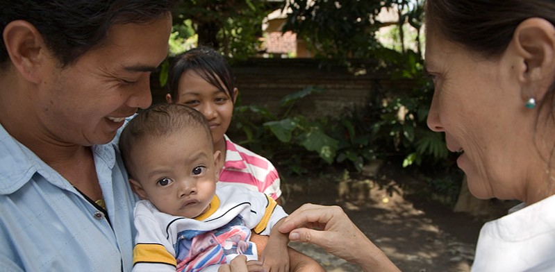 two people playing with a baby