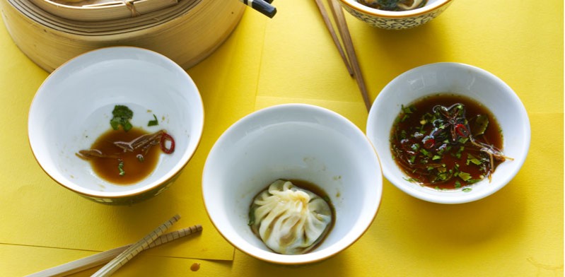 chinese food in bowls on a yellow table cloth