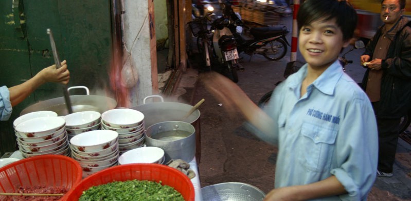 chef cooking vietnamese food in hanoi street