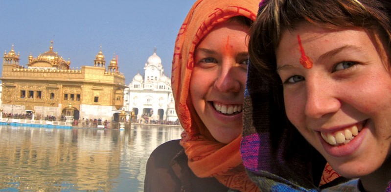 two female travellers smiling in india