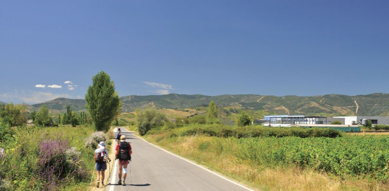 two people walking along the camino de santiago