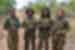 Group of 4 members of the black mambas stand proud in the African brush