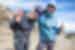 Hiker smiles with leader on the way to Mount Kilimanjaro