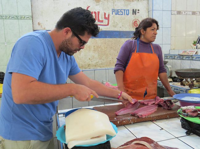 Preparing fish at Mercado de Ica Peru