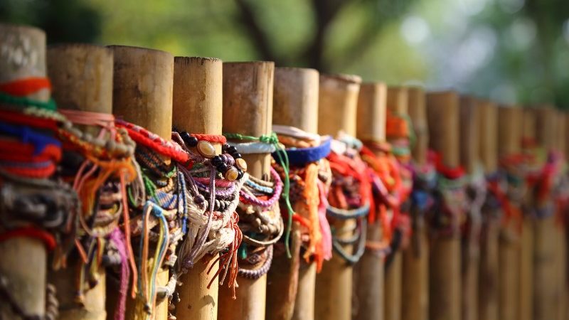 Colourful bracelets on a fence in Cambodia