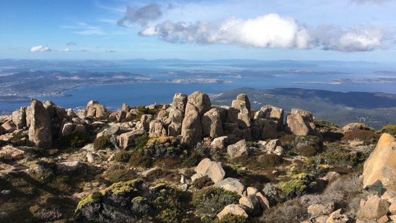 A rocky mountain range overlooking the ocean in Tasmania, Australia