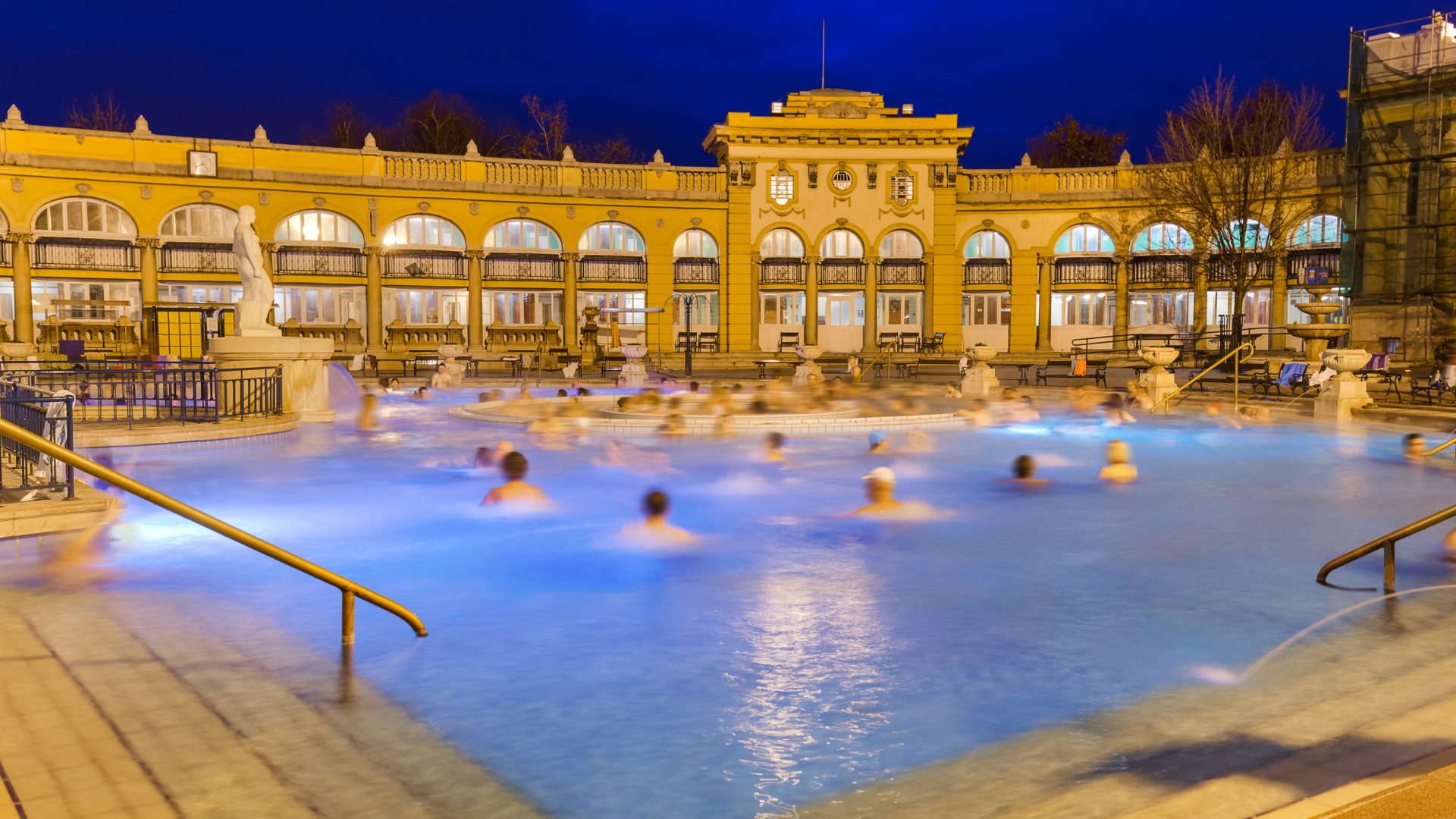 Bathers in an outdoor thermal pool at night at Szechenyi Baths, Budapest