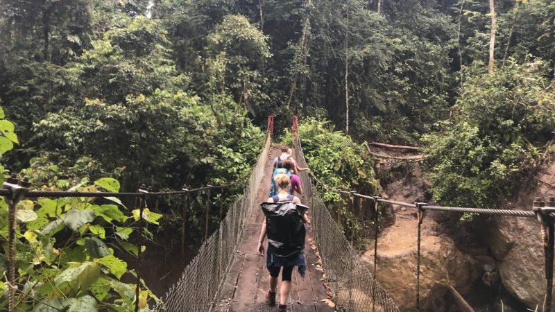 Travellers cross a rickety bridge over the Savegre River in Costa River