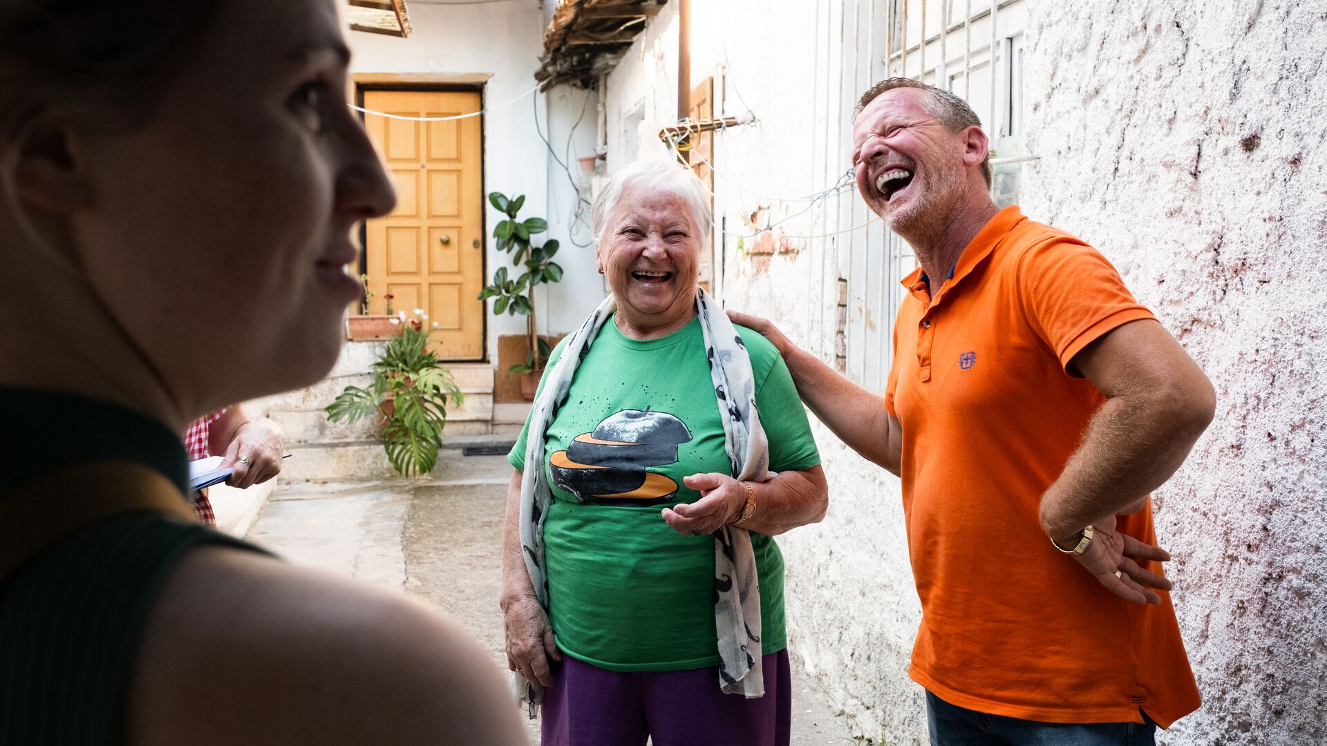 A traveller laughing with a local in Tirana