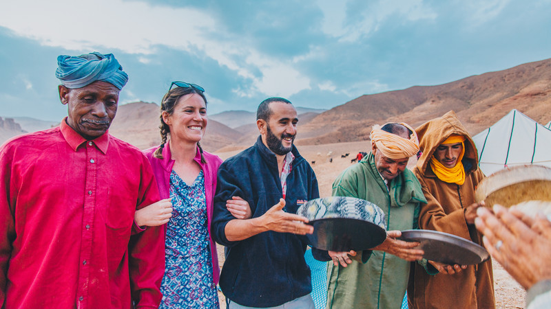 A female traveller with a small group of Berber men in Morocco