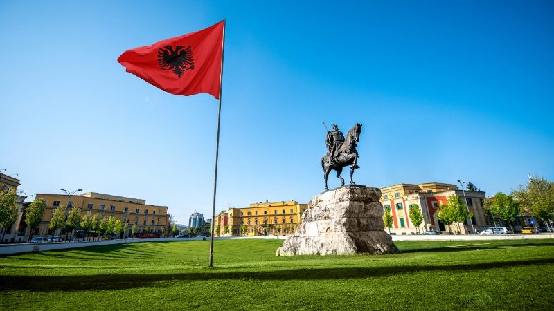 Albanian flag and statue