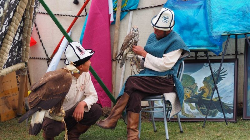 Two falconers chat in Kyrgyzstan