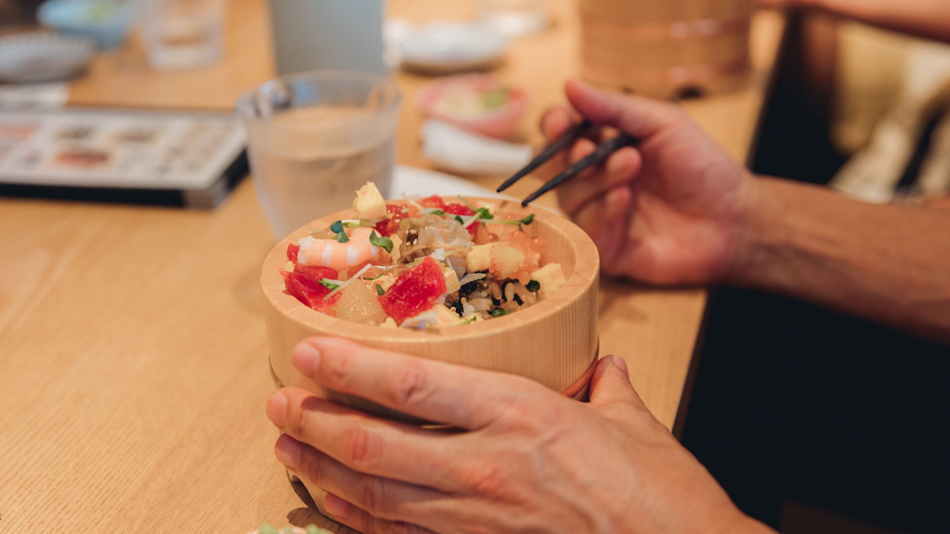 A traveller mastering chopsticks during a meal in Japan.