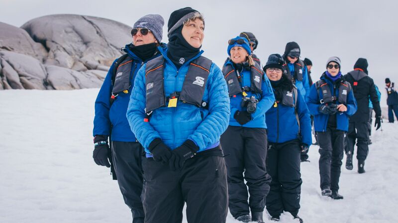 A group of travellers rugged up against the cold in Antarctica