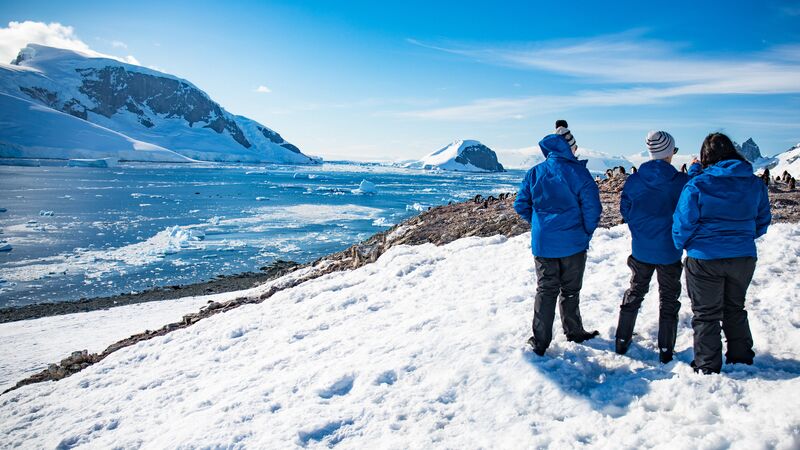 Three people walking in the snow