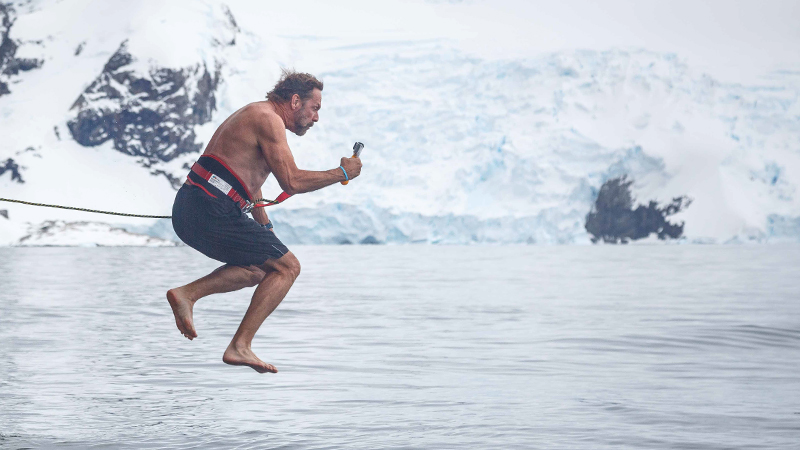 A man jumps off the boat into the water