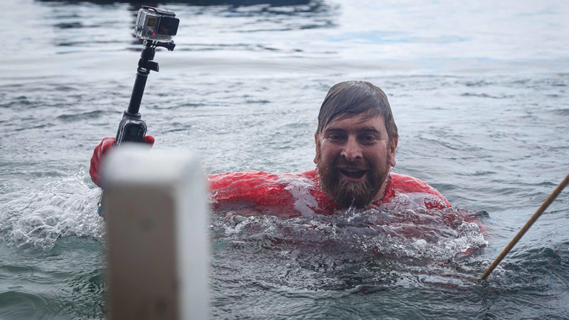 A passenger emerges from the water