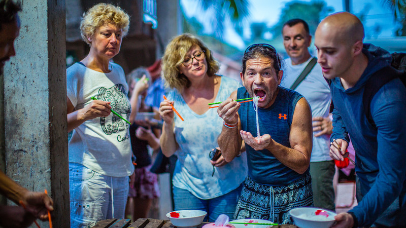 Travellers eating noodles