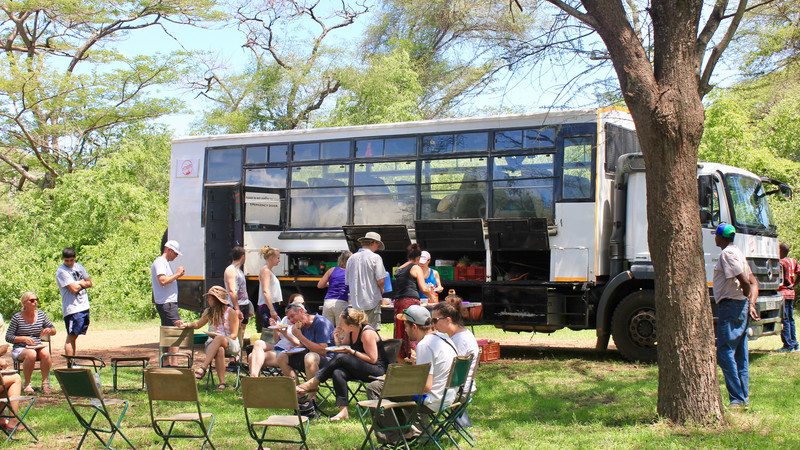 Travellers eating lunch in the Serengeti