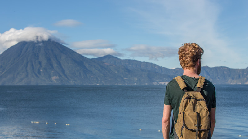 Traveller looks out over Lake Atitlan, Guatemala