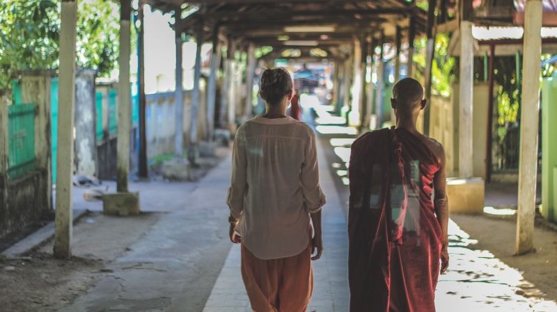 Young woman and monk in Myanmar