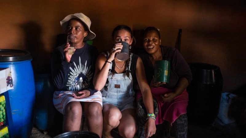 Three women drinking in a shebeen