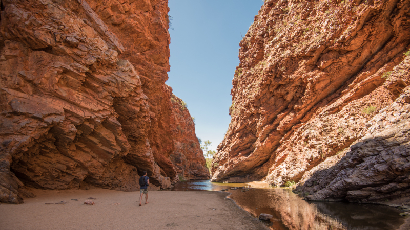 Solo traveller walking through the MacDonnell Ranges in Australia