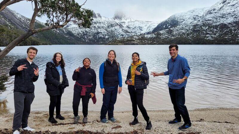 A group of travellers standing before the lake at Cradle Mountain