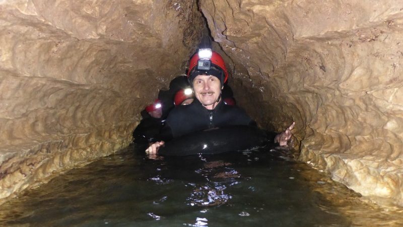 Travellers in water in Waitomo cave