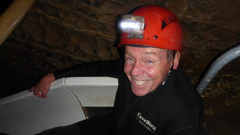 Man at waterslide in Waitomo Cave