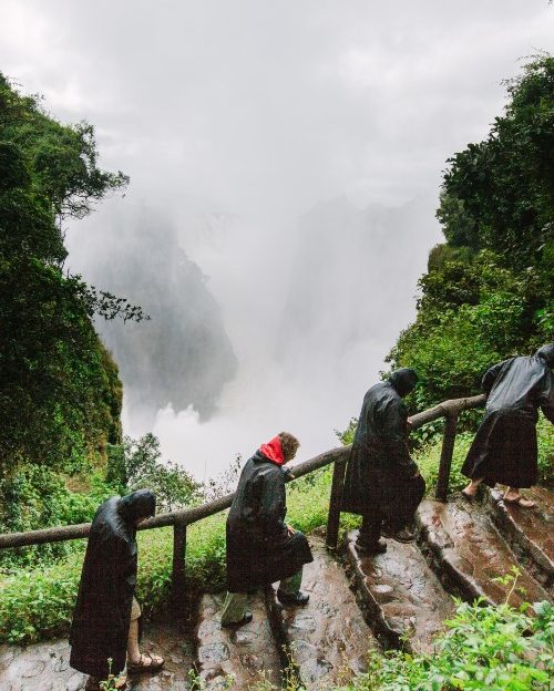 Travellers in raincoats at Victoria Falls