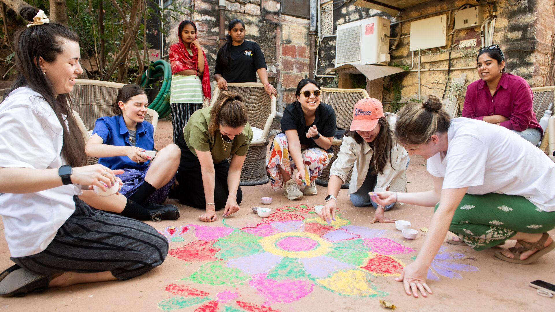 Intrepid traveller creating a rangoli for Diwali on the Women's Expedition.