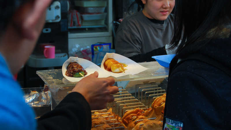 Lining up to buy street food in Japan