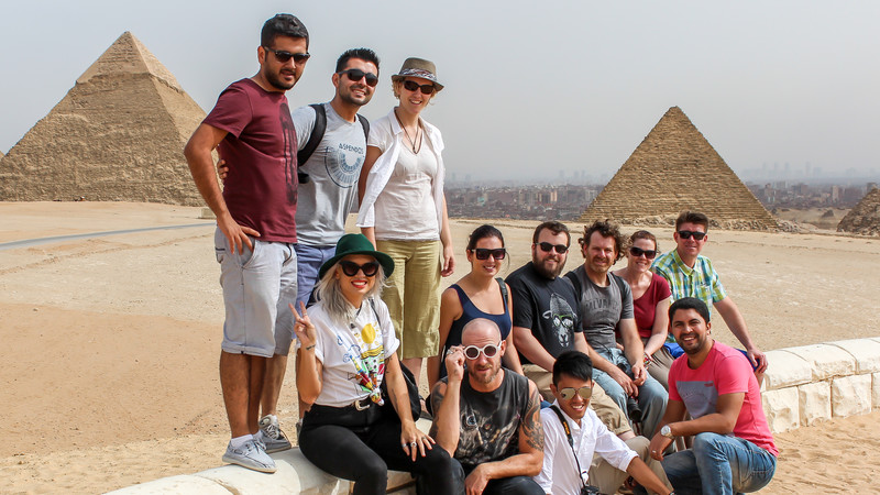 Group of travellers in front of the Pyramids, Egypt