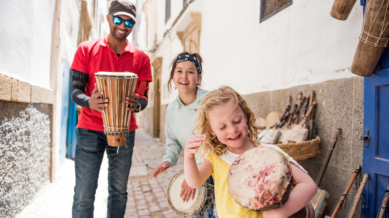 Two kids and their tour guide in Morocco