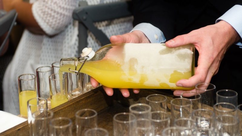 Pouring limoncello into glasses