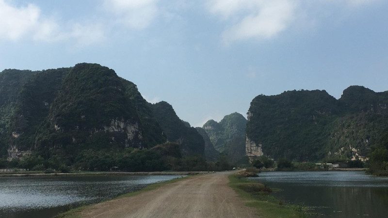 A dirt road between two karst mountains in Vietnam