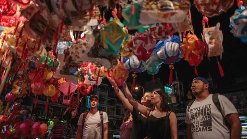 Travellers admiring coloured balloons in Vietnam