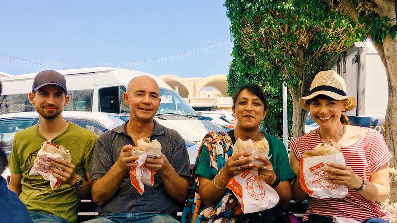 Four travellers eating felafel