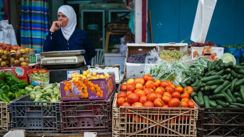 A shopkeeper sells fresh fruit at the market