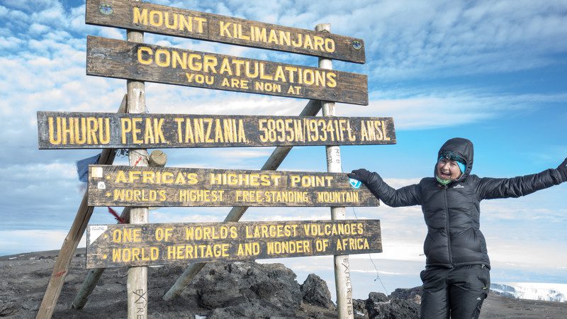 A hiker at the summit of Mt Kili