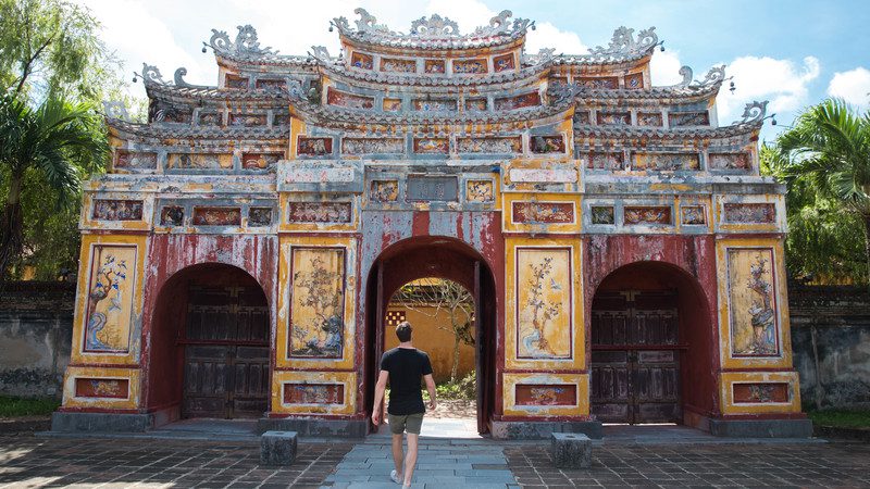 Man walking into a temple in Hue