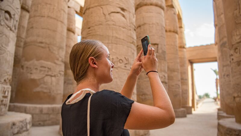 A young woman taking a photo in Egypt