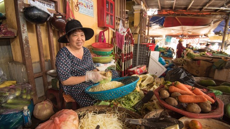A woman selling papaya at the market