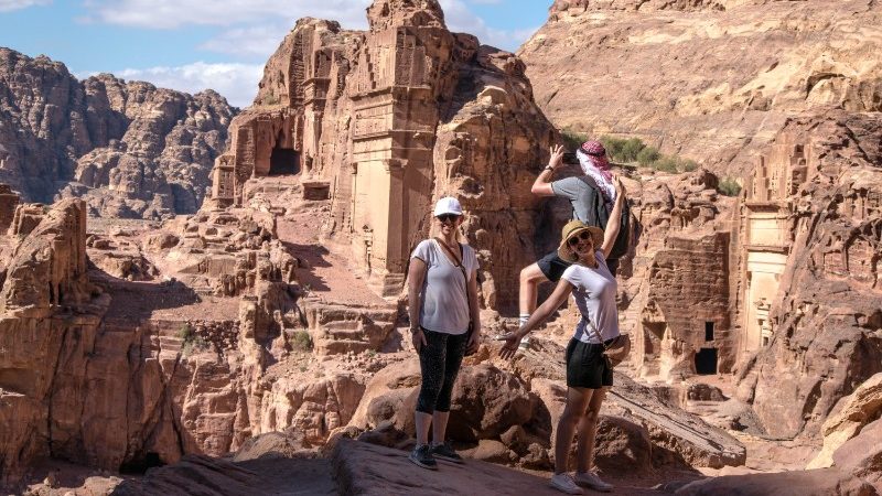 Travellers posing at The Treasury building in Petra